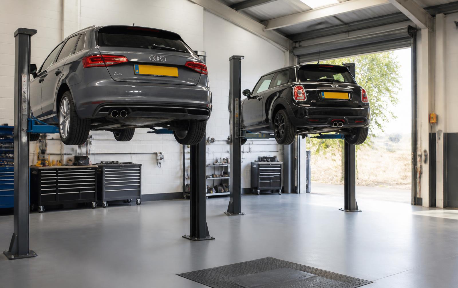 Interior of the Stockport Mechanics workshop with vehicles on ramps